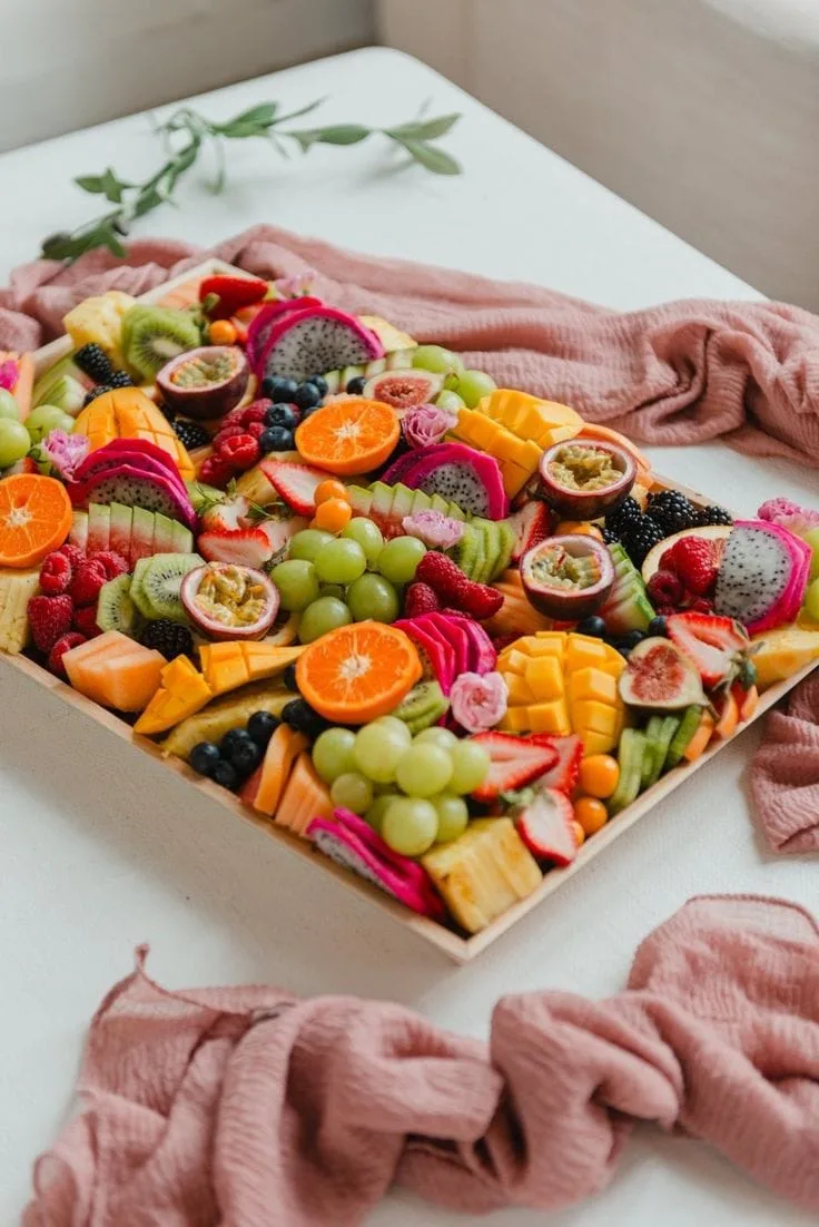 A vibrant Eat Good Club fresh fruit platter of dragonfruit, mango, kiwi and berries.